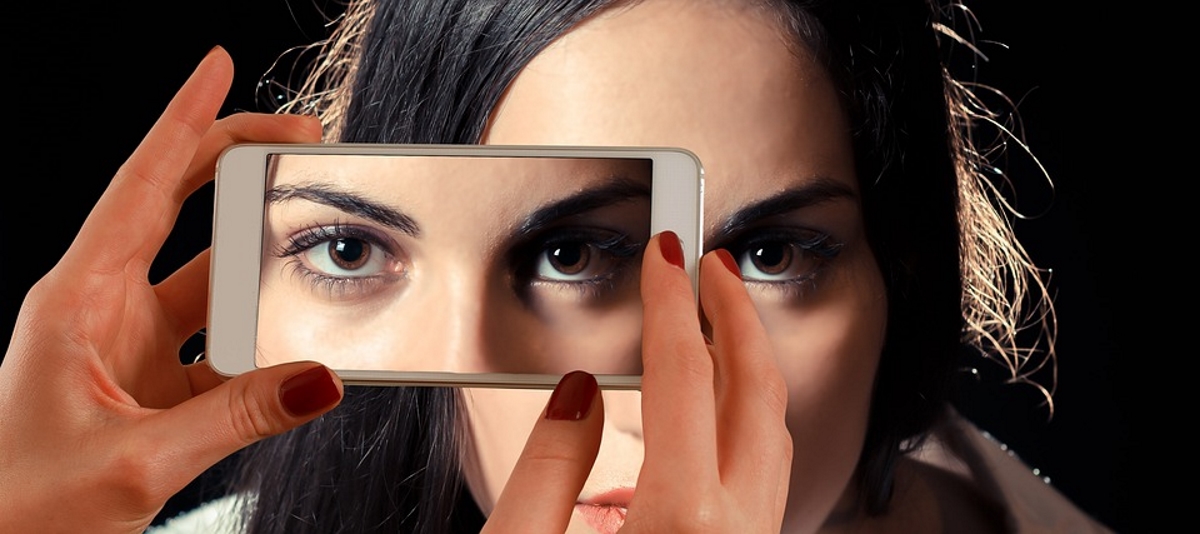 Woman eyes mobile smartphone viewability