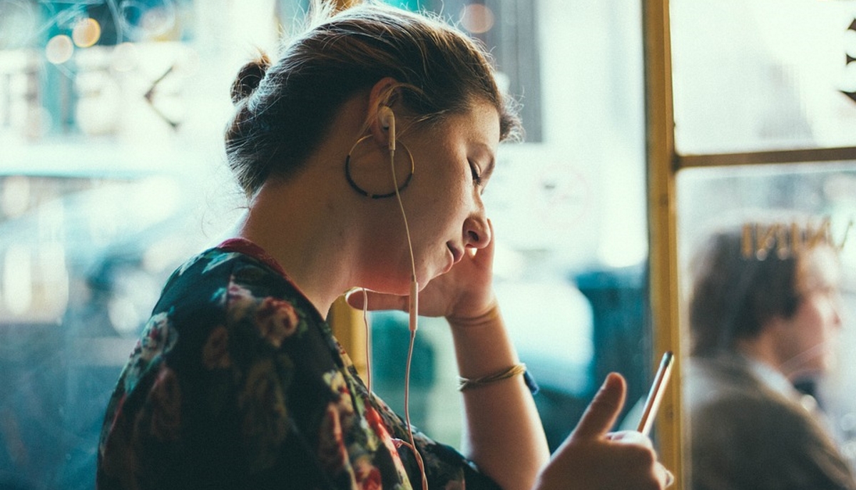 Woman mobile headphones unhappy